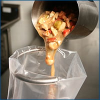 Pouring Stew Into Cook Chill Bag